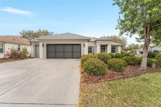 view of front of home with driveway, an attached garage, and stucco siding