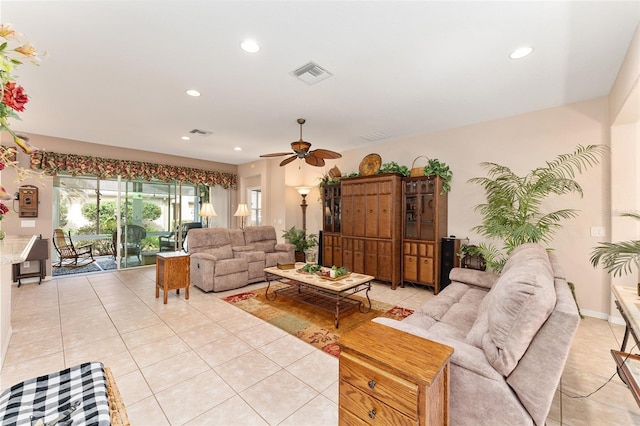 living area featuring light tile patterned flooring, recessed lighting, a ceiling fan, baseboards, and visible vents