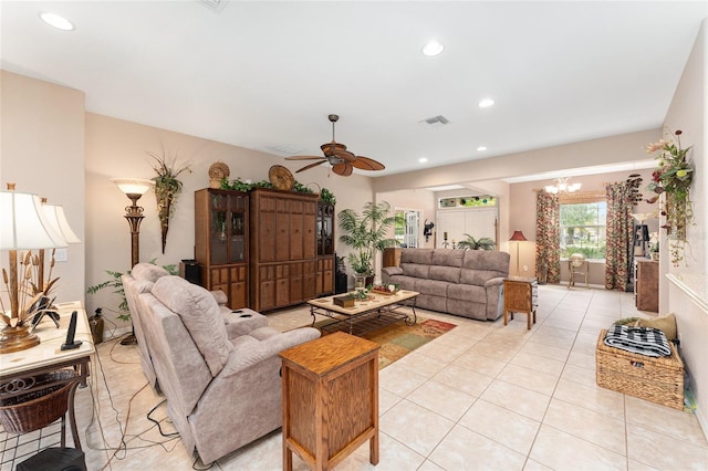 living room featuring ceiling fan with notable chandelier, light tile patterned flooring, visible vents, and recessed lighting