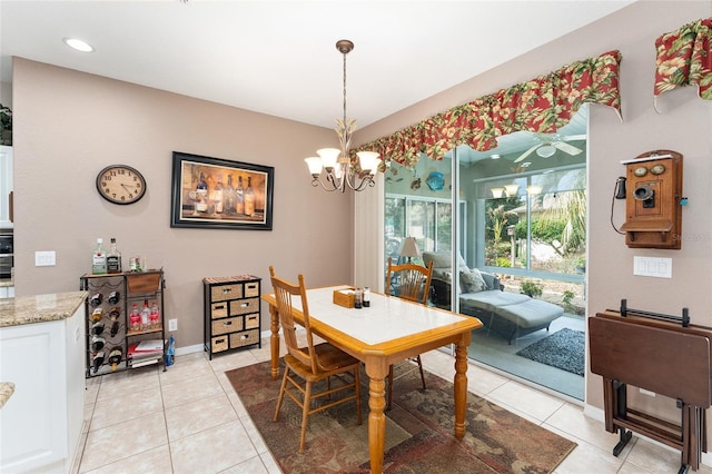 dining room featuring light tile patterned floors, baseboards, and a notable chandelier