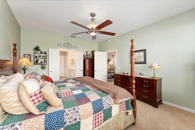 bedroom featuring visible vents, ensuite bathroom, a ceiling fan, light carpet, and baseboards