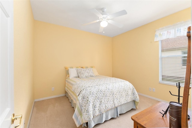 bedroom with a ceiling fan, carpet flooring, and baseboards