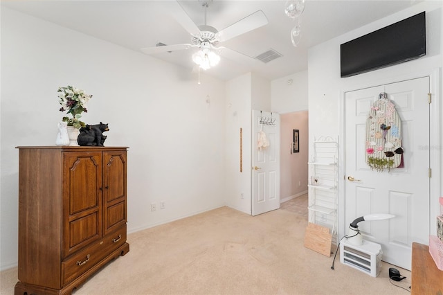 bedroom with light colored carpet, ceiling fan, visible vents, and baseboards