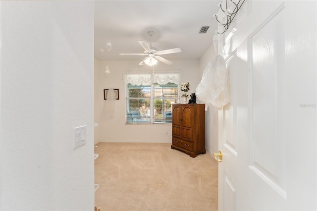 carpeted bedroom featuring a ceiling fan and visible vents