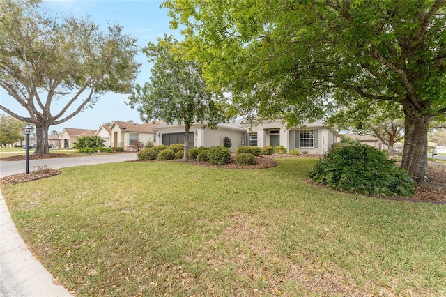 view of front facade featuring an attached garage, a front lawn, concrete driveway, and stucco siding