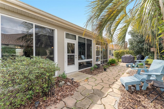 view of patio featuring a sunroom