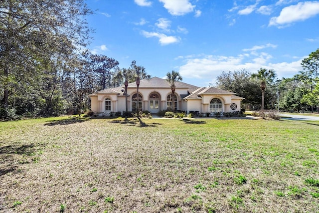 mediterranean / spanish-style house with a front lawn and stucco siding