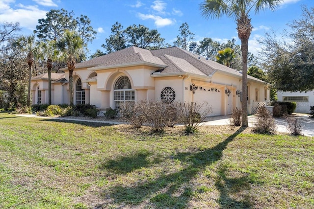 view of front facade with a garage, roof with shingles, a front yard, and stucco siding