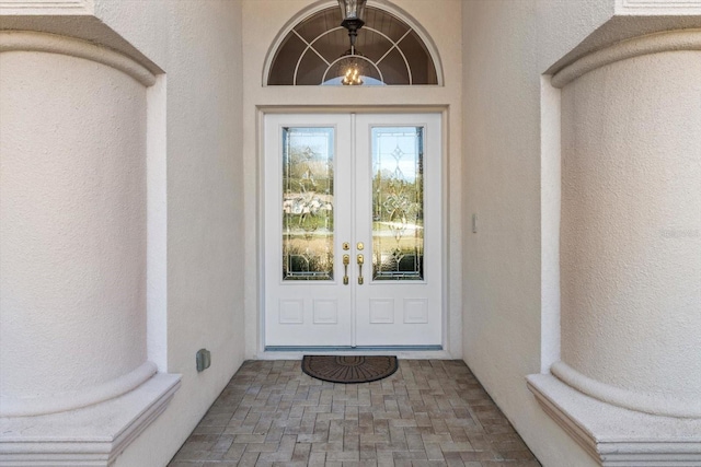 doorway to property with french doors and stucco siding