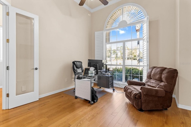 office area featuring baseboards, ceiling fan, ornamental molding, wood finished floors, and french doors