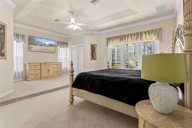 carpeted bedroom featuring access to outside, a raised ceiling, visible vents, and crown molding