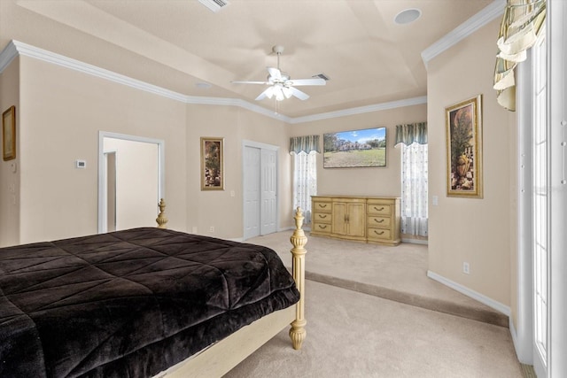 bedroom with baseboards, a raised ceiling, a ceiling fan, ornamental molding, and carpet