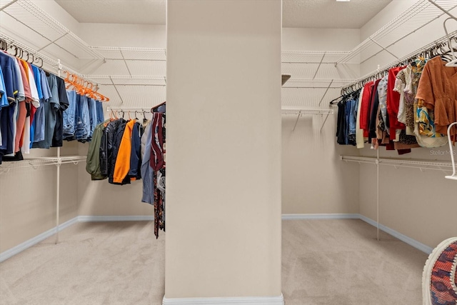 walk in closet with carpet