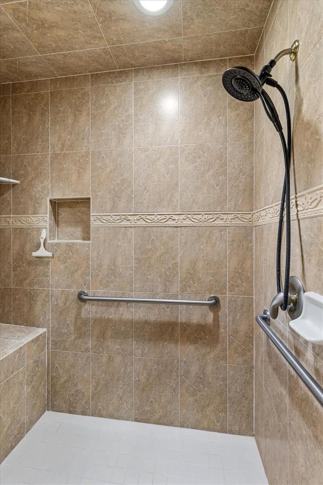 bathroom with a tile shower