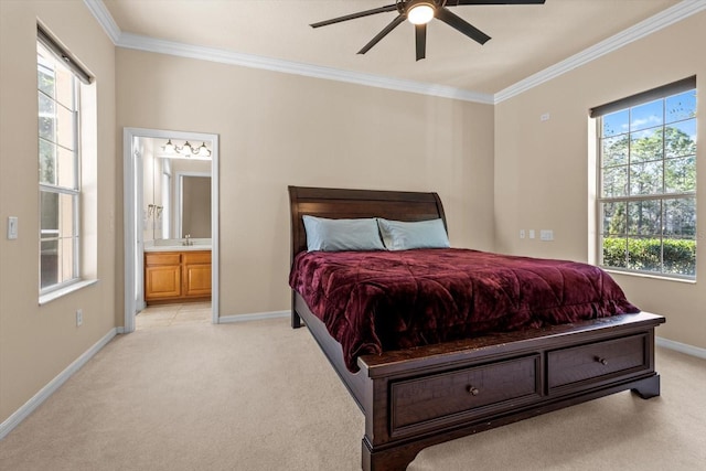 bedroom with baseboards, ensuite bathroom, crown molding, and light colored carpet