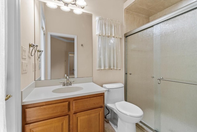 full bathroom featuring a shower stall, toilet, and vanity