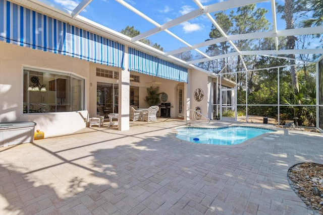 pool with a lanai, a patio, and grilling area