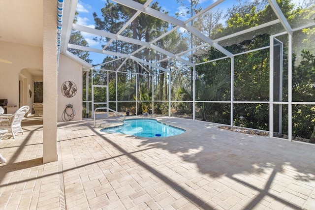 outdoor pool featuring a lanai and a patio