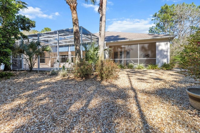 rear view of property with glass enclosure