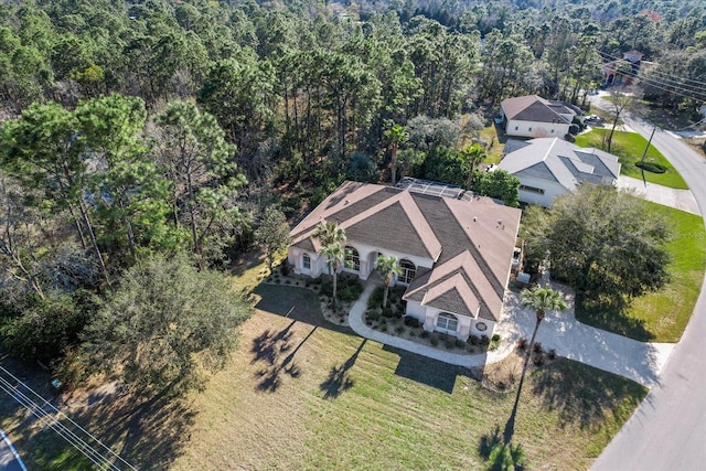 drone / aerial view with a wooded view