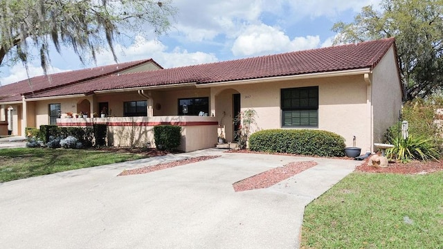 3447 SW 19th Pl, Ocala, FL 34474 - view of front facade with a tile roof and stucco siding