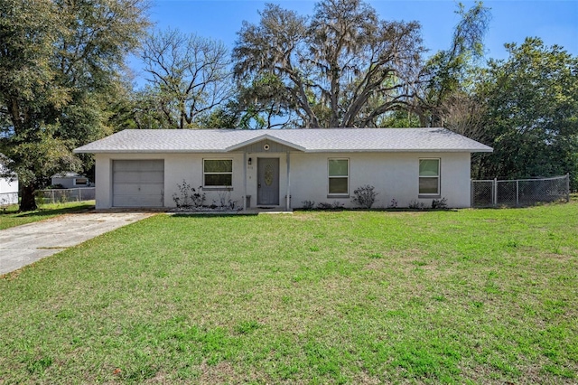 ranch-style home featuring an attached garage, fence, concrete driveway, and a front yard