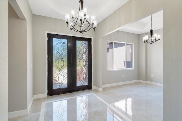 entrance foyer featuring french doors, marble finish floor, baseboards, and an inviting chandelier