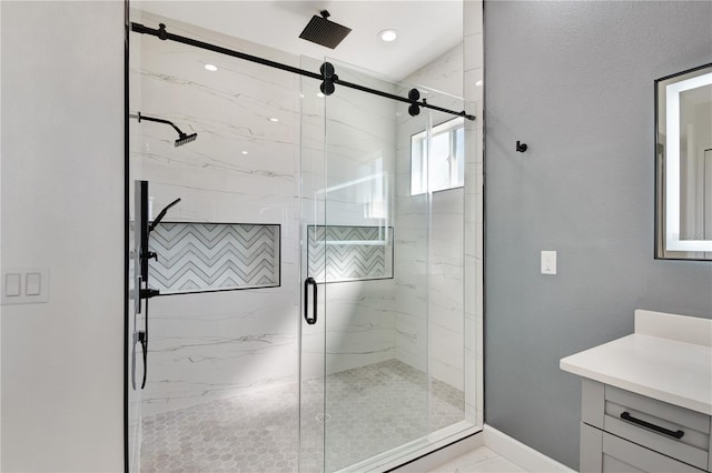 full bathroom with marble finish floor, a marble finish shower, baseboards, and vanity