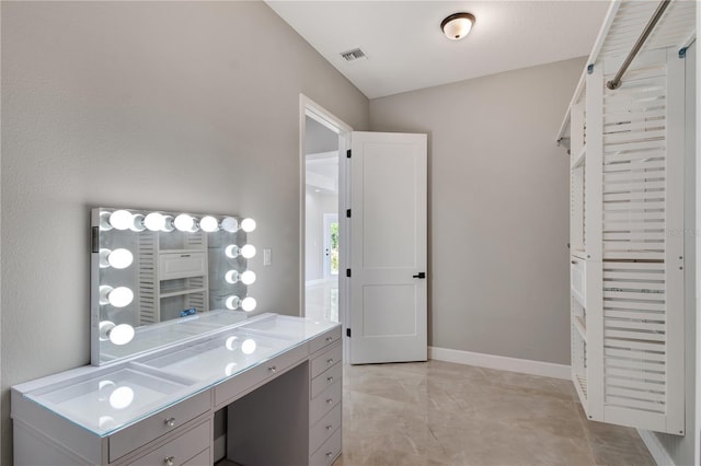 interior space with visible vents, vanity, and baseboards