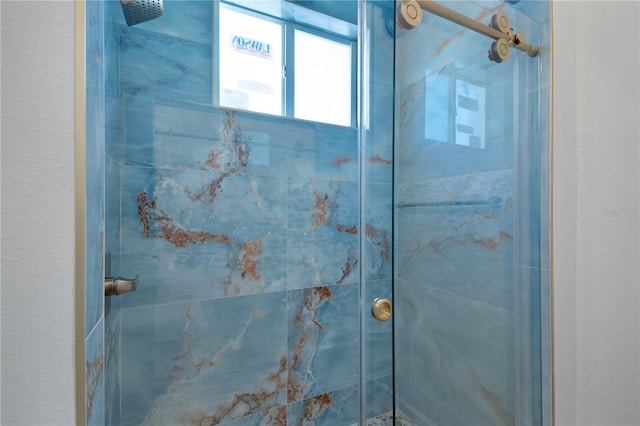 full bathroom featuring a marble finish shower