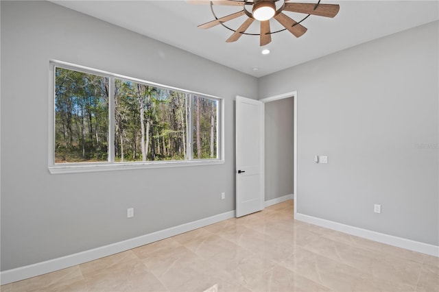 empty room featuring recessed lighting, ceiling fan, and baseboards