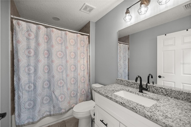 full bathroom featuring a textured ceiling, toilet, vanity, and visible vents