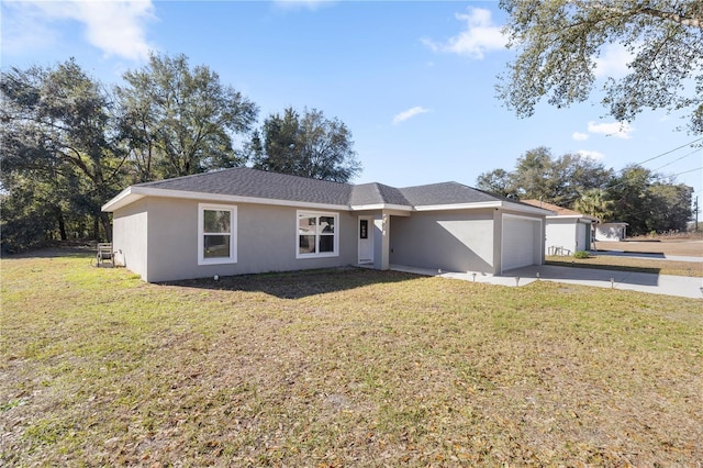 ranch-style home featuring concrete driveway, a front yard, an attached garage, and stucco siding