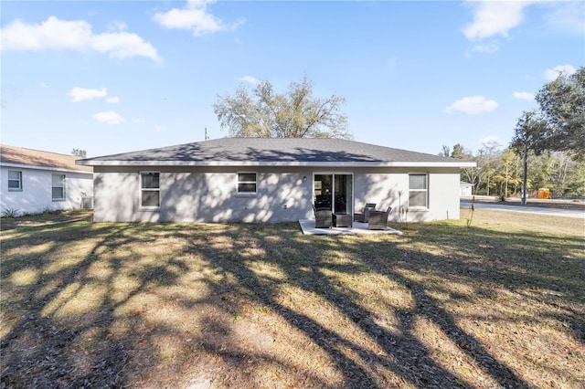 rear view of property featuring a patio area and a yard