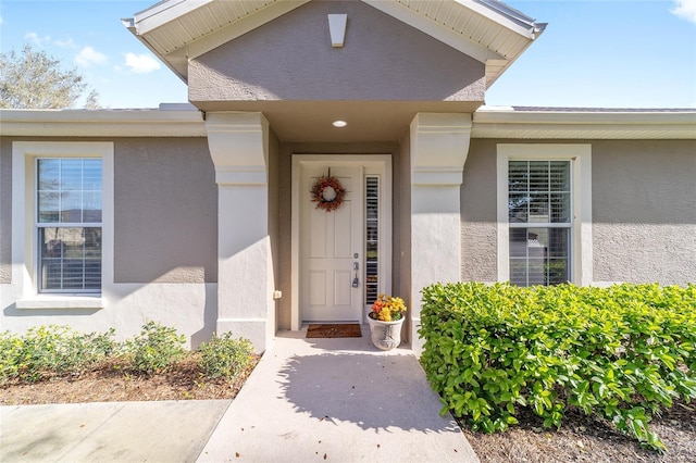 property entrance with stucco siding