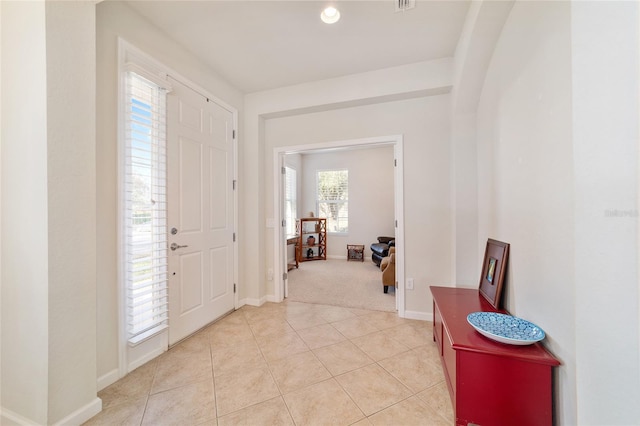 entryway featuring light tile patterned floors and baseboards