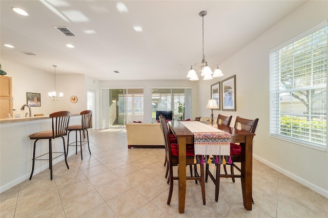 dining space with light tile patterned floors, recessed lighting, visible vents, an inviting chandelier, and baseboards