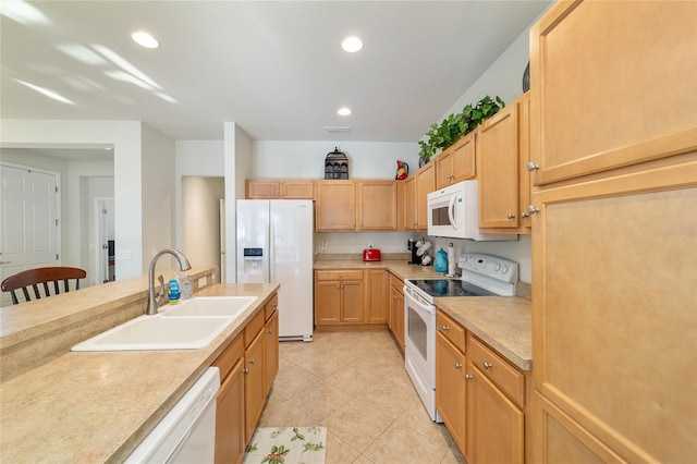 kitchen featuring light tile patterned flooring, recessed lighting, white appliances, a sink, and light countertops