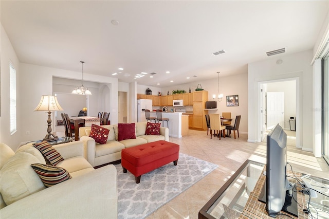 living room featuring light tile patterned floors, visible vents, a notable chandelier, and recessed lighting