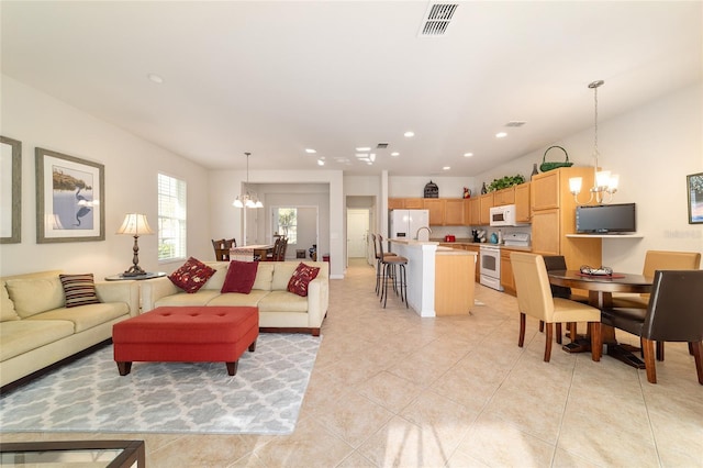 living room featuring a chandelier, recessed lighting, visible vents, and light tile patterned floors