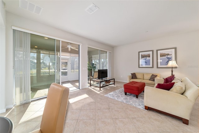 living area featuring light tile patterned floors, baseboards, and visible vents