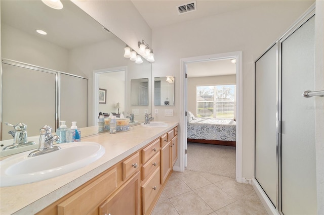 full bath featuring a stall shower, tile patterned flooring, visible vents, and a sink