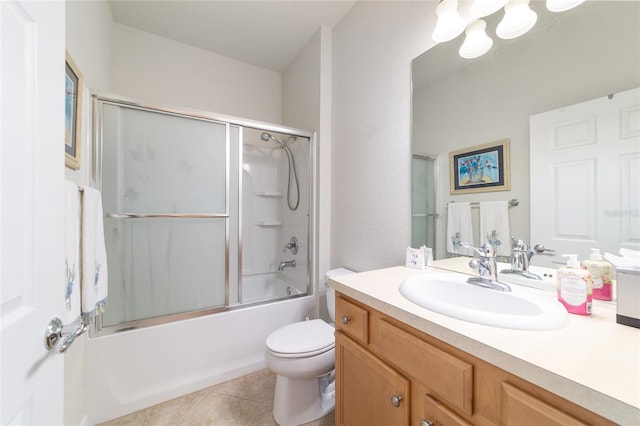 full bath featuring toilet, tile patterned flooring, bath / shower combo with glass door, and vanity