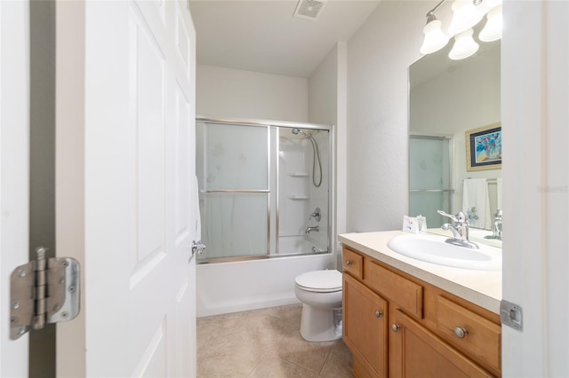 full bathroom featuring visible vents, bath / shower combo with glass door, toilet, tile patterned floors, and vanity