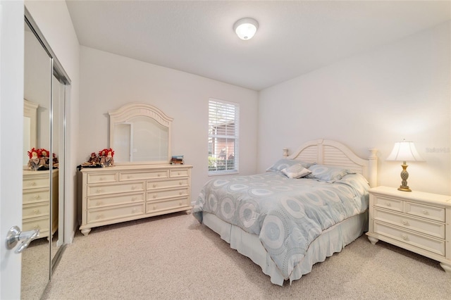 bedroom featuring a closet and light carpet