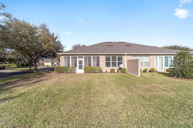 view of front of house with a front yard and stucco siding