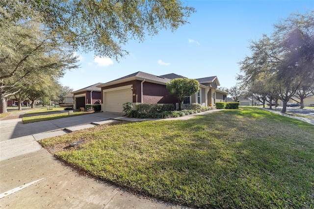 view of front of property featuring an attached garage, concrete driveway, a front yard, and stucco siding