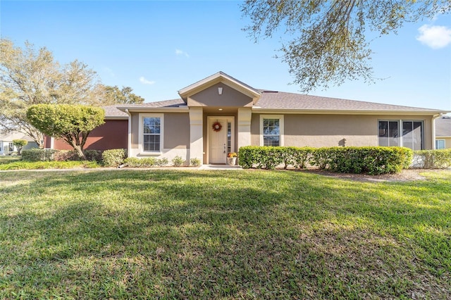 single story home with a front yard and stucco siding