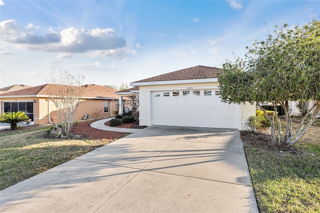 ranch-style house featuring a garage, driveway, a shingled roof, and stucco siding