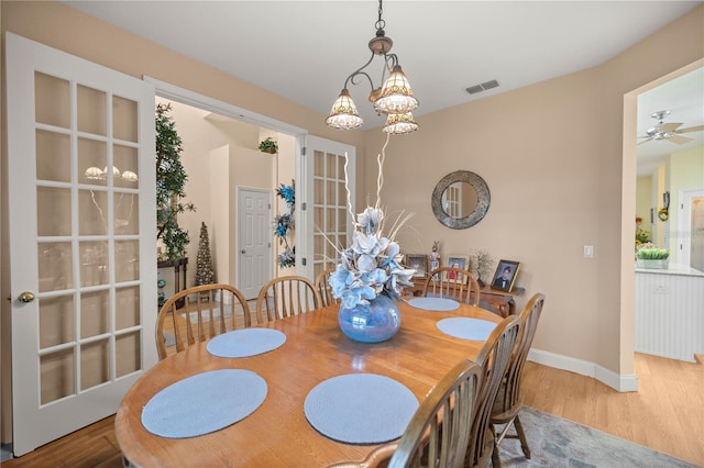 dining space with baseboards and wood finished floors